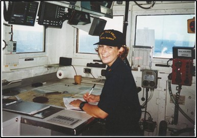 LTJG Mitchell in uniform conducting sound level survey inside a US Coast Guard Cutter.